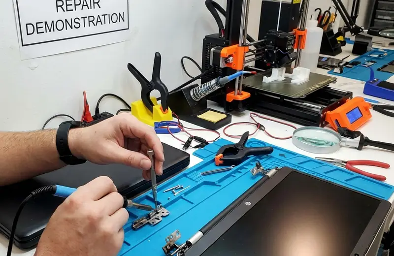 Illustration: a laptop hinge being repaired